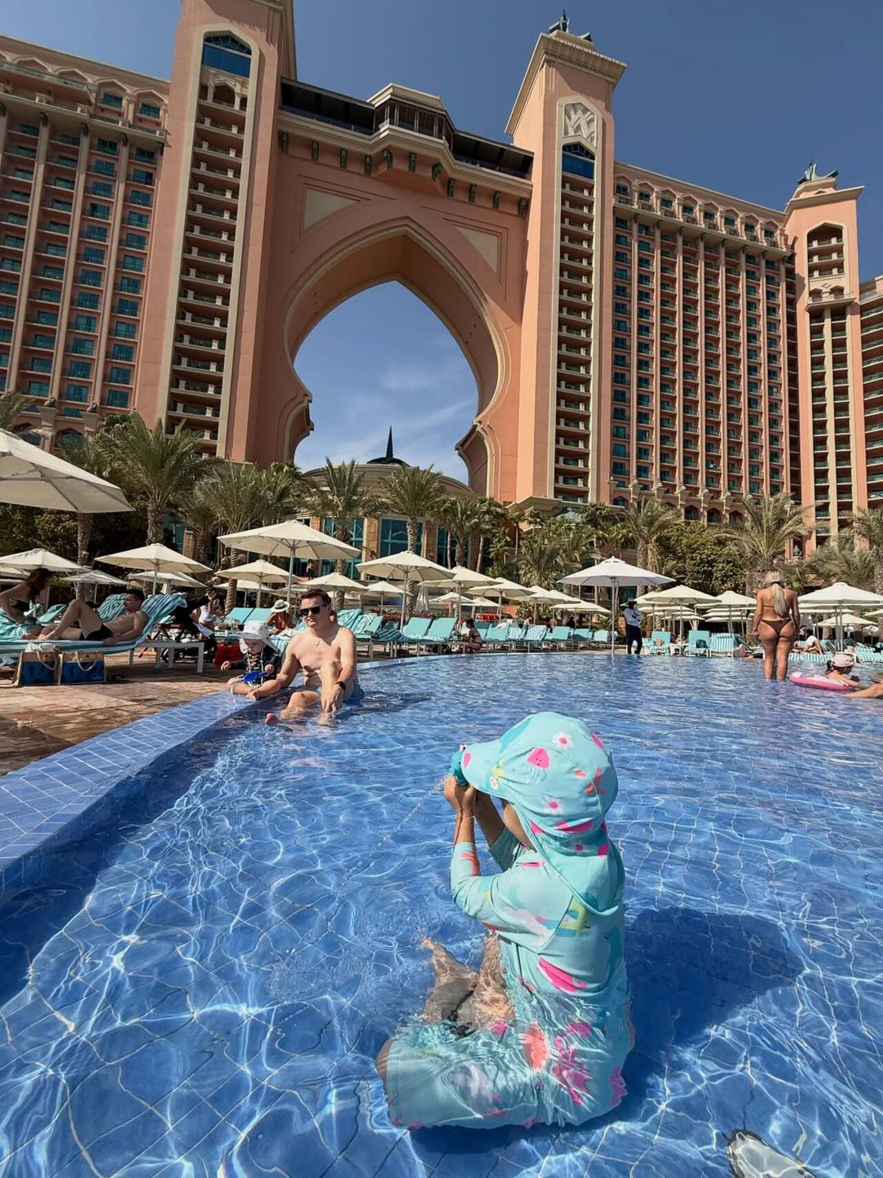 Devi giggled with delight as she soaked up the sun while enjoying a dip into the pool. The little one was clearly enjoying the moment in her cute blue swimsuit.